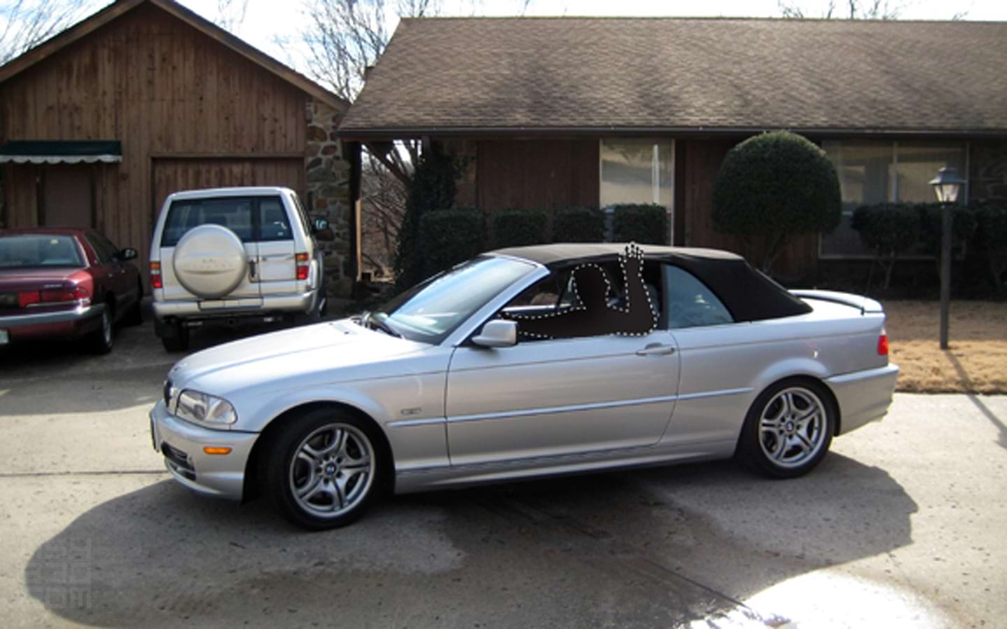 The first moments with the new E46 as the driver waves while pulling out of a driveway.